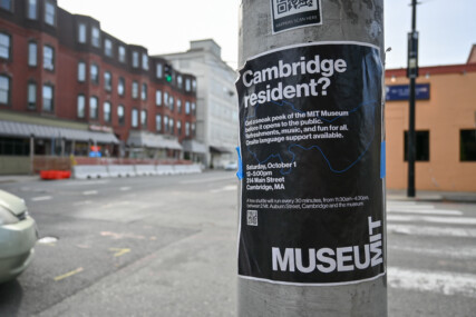 A poster on a lamppost publicising the opening of MIT Museum and a preview event specifically aimed at the local community