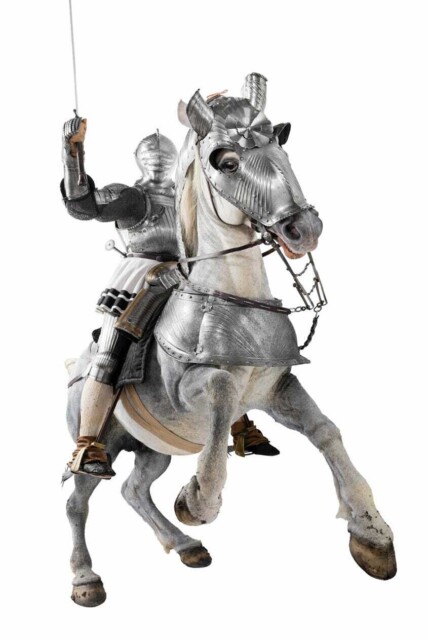 life size model of a rearing white horse in 16th century metal armour with a rider in similar armour