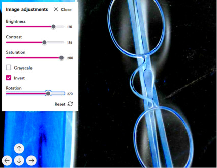 screenshot of the same image viewer as at the top of the page displaying a photo of 19th century brass spectacles with wooden case. here, the image adjustments menu is open displaying sliders for brightness (increased to 170 out of 200), contrast (increased to 135), saturation (increased to 200), and rotation (set to 270 out of 360) and check boxes for grayscale (unticked) and invert (ticked). Due to the changed values, the image now appears to be blue and white on black background.
